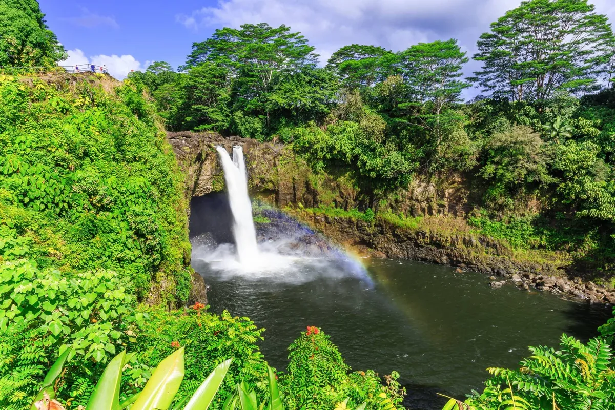 A rainbow arcing through the morning mist below Rainbow Falls, one of the best hilo waterfall photo spots near downtown Hilo, Hawaii